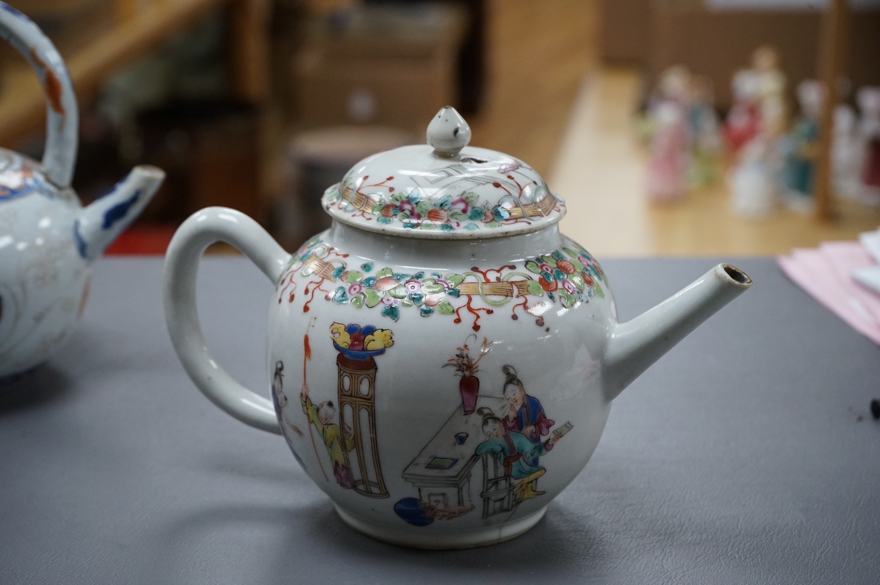 A Chinese famille rose ‘boys and ladies’ teapot, Qianlong period and a Japanese Arita sake pot or ewer, early 18th century, tallest 16cm high.